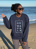 Woman on the beach wearing Tribal Marks’ No Wahala Crewneck sweatshirt in navy blue