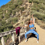 Woman barre flowing on a trail with a scenic mountain background in Ankara print leggings for movement and modern wellness – No Wahala indigo pattern activewear