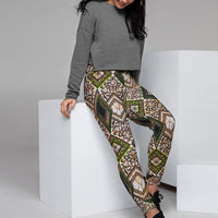 Woman sitting on a block wearing Tribal Marks' Wonder Momma Ankara Print Women's Ankara Joggers