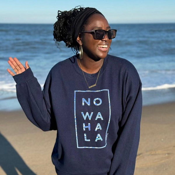 Woman on the beach wearing Tribal Marks’ No Wahala African Ankara Graphic Print Crewneck sweatshirt in navy blue with inspiring hope quote to fight anxiety