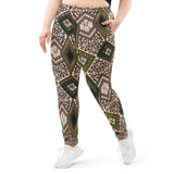 Front view of a woman wearing Tribal Marks' he Proverb Ankara Print Graphic Women's Ankara Joggers